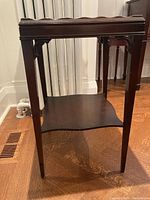 Full side view of antique wood occasional table showing construction, legs and lower shelf