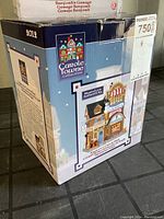 Photo of Carole Towne Angie's Ice Cream Shop original box showing front with labeled image of the building and authenticity mark.