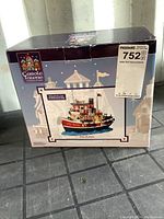 Original boxed Carole Towne Collection 'The Robin' tugboat Christmas village decoration with label and packaging intact.