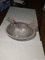 Side profile showing hen atop nest.