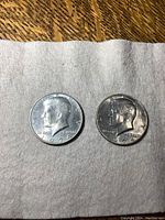 Front view of two 1974 US half dollar coins showing Kennedy's profile and inscriptions