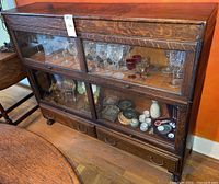 Front view showing four glass doors and two drawers below