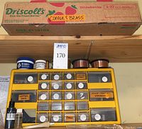 Overview of Driscoll's box labeled ‘COPPER & BRASS’, plastic sorter, wire spools and polish tins