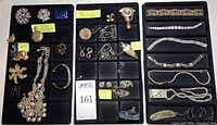 Three black velvet trays showing the full assortment of jewelry items laid out