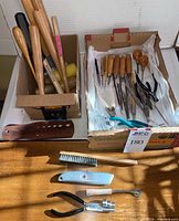 Overview of two boxes: left box with mallets and hammers, right box with assorted small tools