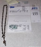 Full view of the sterling silver chain with Ganesh pendant and purchase receipt.