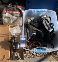 Full view of Alpine Premier tire chains in original bags, electric air horn in box with compressor and trumpets, and Yakima roof carrier parts in storage bin