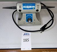 Front view of TM-2 Bench Lathe polisher on table with power cord visible