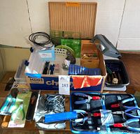 Overall lot view showing wooden box, blue pliers case, plastic bins, magnifier, templates