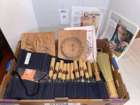 Overview of denim roll, chisels, mallet, brush, panels and publications