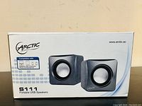 Front view of the Arctic S111 portable USB speakers box showing product image and compatibility with PC, iPad, iPhone, and smartphone.