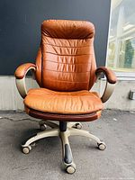 Front view of chair on black backdrop and concrete ground