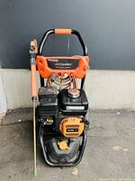 Front view of power washer showing frame, engine, hose and wand