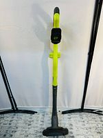 Front view of Ryobi weed wacker showing full length, handle, shaft, and cutting head with guard.