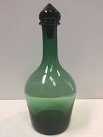 Front view of the green glass Blenko decanter with stopper in place, showing shape and color gradient.
