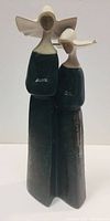 Front view of the Lladro nun figurine showing two side-by-side nuns in dark habits and white veils.