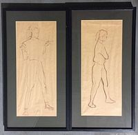 Photo of both framed drawings side by side on the floor showing full artwork and frames.