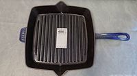 Full view of Staub blue cast iron grill pan from top showing ridged grill surface and square shape with two spouts.
