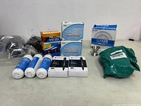 Photo of all items in the lot including markers, rubber bands, gloves, filters, jigger, and miscellaneous wrapped item