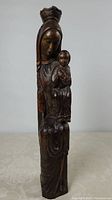 Front view of tall wood carving Virgin Mary with Child Jesus showing overall shape and height.