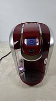 Front view of red Keurig 2.0 coffee maker showing overall condition and design.