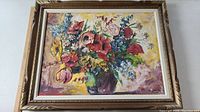 Full view of framed oil painting showing floral still life composition