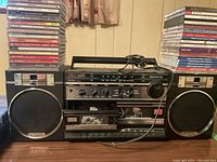 Front view of vintage black Sanyo boombox with cassette player, dual speakers, and control panel.