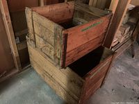 Photo of two vintage wooden boxes stacked, showing wood texture, metal corner braces, and wear.
