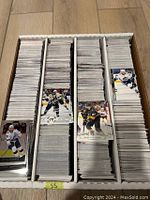 Top view of a divided box with 3200+ hockey base cards in four vertical stacks.