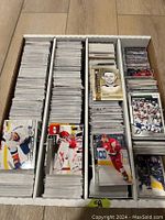 Box with a large collection of hockey cards divided in several sections, cards mostly from 2010s to current.