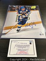 Photo of Adam Oates in St. Louis Blues jersey, hockey action shot, autograph in blue on front with Certificate of Authenticity from Frozen Pond.