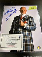 Photo of signed 8x10 Don Cherry photo with certificate of authenticity in protective sleeve.