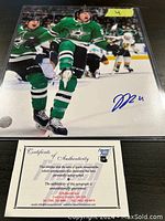 Signed 8x10 photograph of Jason Robertson in Dallas Stars uniform, showing the autograph in blue ink and certificate of authenticity below.