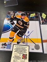 Signed 8x10 photo of Milan Lucic in Bruins uniform with COA and protective sleeve