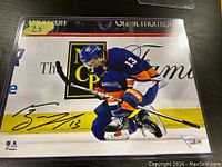 Photo of signed 8x10 Mathew Barzal photo in Islanders uniform in protective sleeve