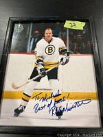 Framed color photograph of Rick Middleton in Boston Bruins uniform, autographed in blue ink with a personalized message.