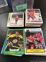Top-down view of grouped vintage hockey cards showing individual cards and thick stack.