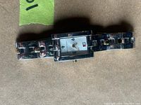 Front view of Tommy Hilfiger women's wristwatch showing rectangular dial and bracelet.