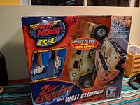 Front view of unopened Air Hogs RC Zero Gravity Wall Climber Humvee sealed in original box with tape, showing branding and product images on packaging.