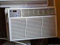 Front view of GE window air conditioner showing control panel and vent louvers.