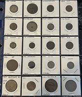 Full layout of 20 assorted world coins in protective holders, showing front side with dates and denominations visible.