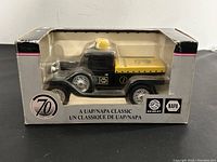 Front view of die cast Ford Model A truck in original packaging showing black and yellow color scheme, 70th anniversary and NAPA logos.
