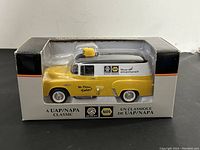 Front view of the boxed die-cast truck showing yellow and black panel truck with NAPA and UAP logos.