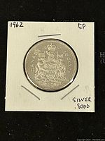Obverse side of the 1962 Canadian 50 cent coin showing the Canadian coat of arms with year, denomination, and silver content noted on holder.