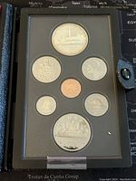 Full front image of the 1984 Canadian Silver Proof Double Dollar Set with all seven coins in protective black folio.