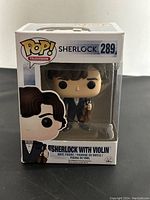 Front view of boxed Funko Pop! Sherlock with violin figure, number 289.