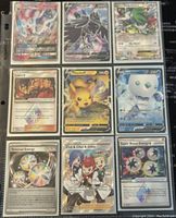 Photo showing nine Pokémon trading cards in protective sleeves featuring characters Sylveon V, Zoroark V, Sceptile EX, Pikachu, and various Trainer cards.