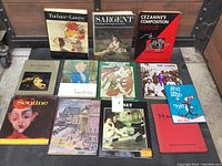 Photo showing 12 art books spread out with visible titles such as Toulouse-Lautrec, Sargent, Cézanne's Composition, The Nabis, Soutine, and others.