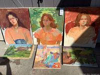 Photo showing six canvas paintings including three large unfinished portraits and three smaller landscape studies, displaying brushwork and unfinished areas.