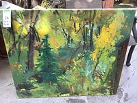 Photo of green landscape painting showing dense trees with green and yellow foliage, rectangular canvas with visible brushstrokes